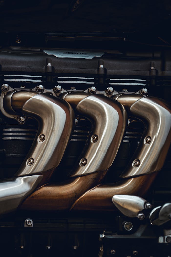Detailed look at polished metal engine exhaust pipes showing craftsmanship in technology.